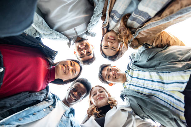 istock Multiracial friends together in a circle looking at camera 1423390701