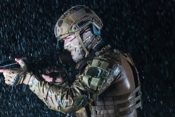 armeesoldaten in kampfuniformen mit sturmgewehr, plattenträger und kampfhelm auf eine gefährliche mission in einer regnerischen nacht. - real people caucasian one person black and white stock-fotos und bilder