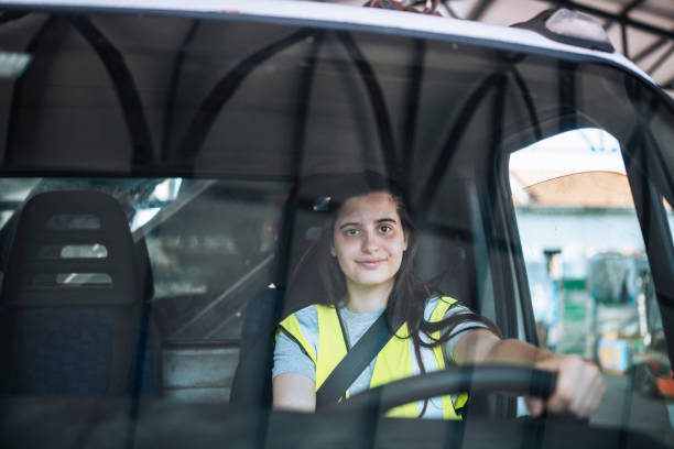 istock Female truck driver photographed through window. 1423392097