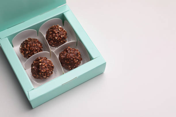 istock Delicious chocolate candies in turquoise box on light grey background, space for text 1423392419