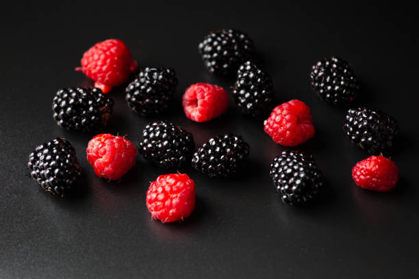 Blackberries scattered on a red tablecloth. blackberry berries close-up