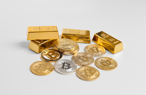 Heap of bitcoin coins and gold bars isolated on white background. Cryptocurrency close-up on isolation. Ingots of gold. Currency growth concept