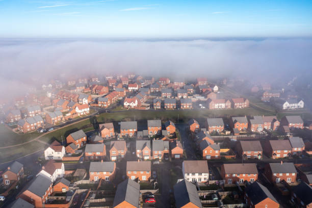 aerial view of city under the fog in england - housing development birmingham uk row house imagens e fotografias de stock