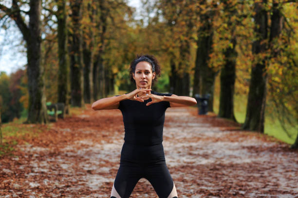woman outdoors with arms on chest meditating