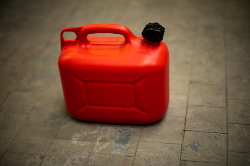 Red canister of fuel. Oil tank.
