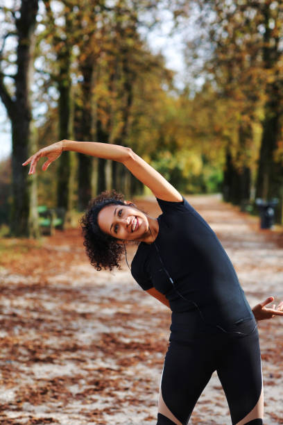 istock positive middle aged woman stretching outdoors preparing for exercise 1423394281