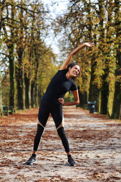 istock positive middle aged woman stretching outdoors preparing for exercise 1423395848