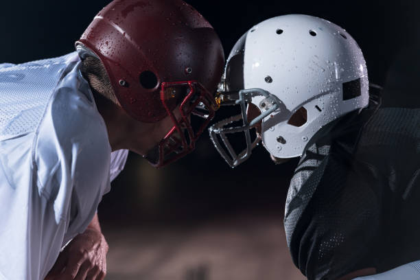 two american football players face to face in silhouette shadow on white background - real people blue white friendship imagens e fotografias de stock