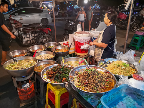 Chiang Mai, Thailand - September 15, 2019: Thai street food sellers at the night market in Chiang Mai, Thailand