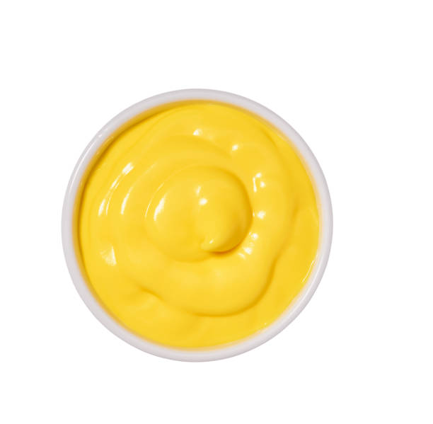 Cheese sauce in ceramic bowl isolated on white background.Top vi Small ceramic  bowl of yellow sauce  isolated on white background.Creamy Cheddar sauce cheese sauce stock pictures, royalty-free photos & images