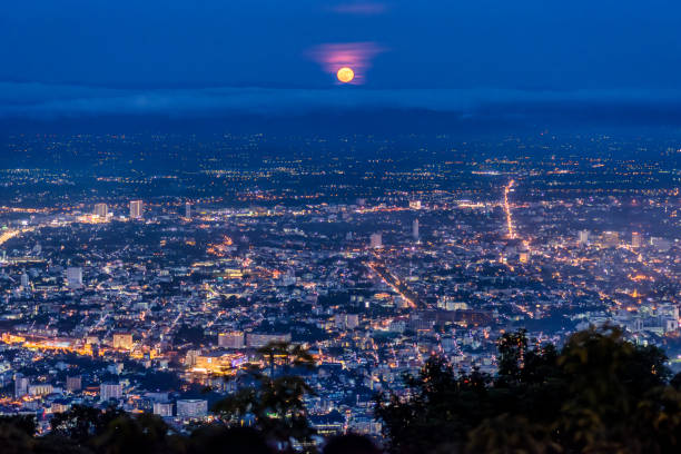 Full moon over Chiang Mai, Thailand Full moon raising over Chiang Mai city. Aerial view skyline during night with illuminated street light. Thailand chiang mai city stock pictures, royalty-free photos & images