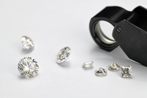 istock Diamonds and Jewelry Loupe on White Background 1423401617