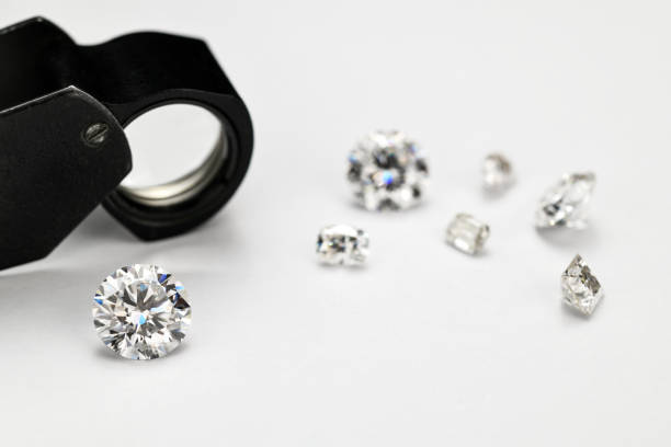 istock Diamonds and Jewelry Loupe on White Background 1423401676