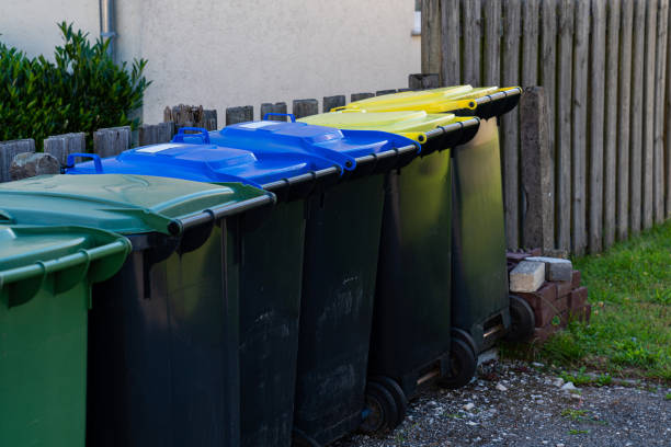 istock Row of plastic trash cans along the fence. 1423401761