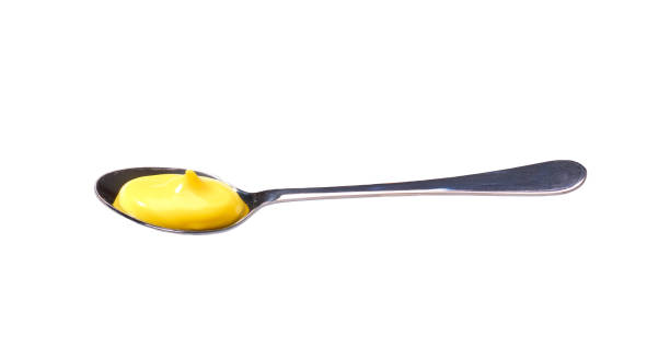 istock Cheese sauce in small metal spoon  isolated on white background, 1423401883