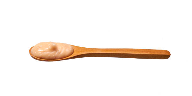 istock Shrimp sauce in small wooden spoon isolated on white background 1423401907