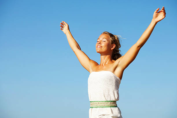 Young woman with arms raised