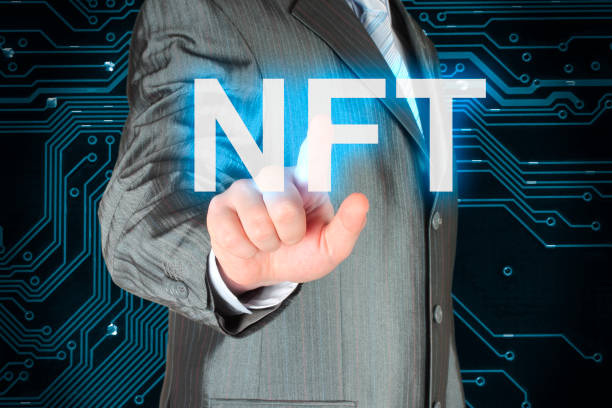 istock Businessman pushing virtual NFT button, on digital background 1423404761