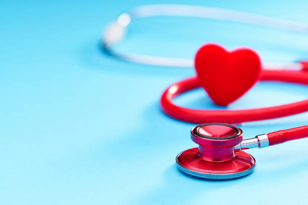 istock Red heart and stethoscope on on blue background.Selective focus. 1423405246