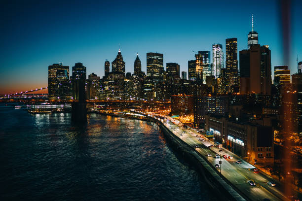 istock Manhattan skyscrapers and bridge in evening 1423407478