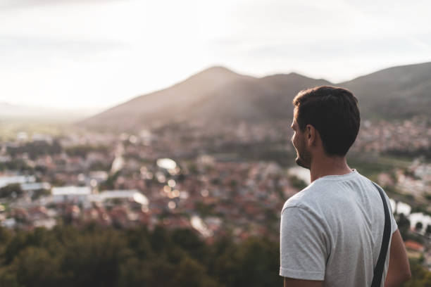 istock Young man breathing fresh air in mountains at sunset 1423409933