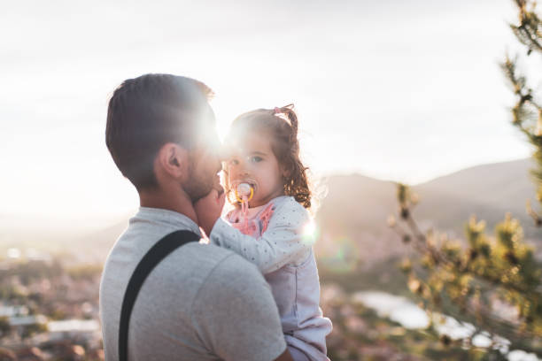 istock Young father and daughter in mountains at sunset 1423410310