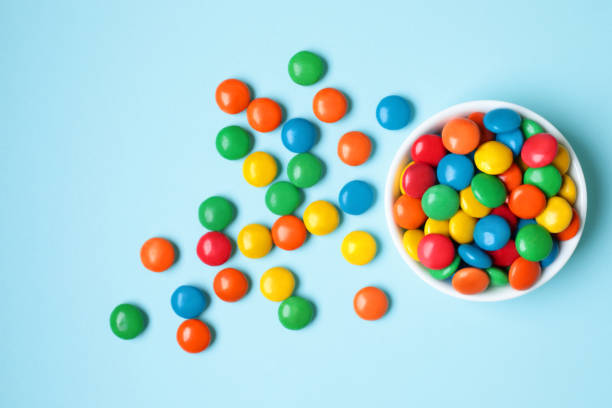 istock Vessel with Color Candies on blue background 1423410439