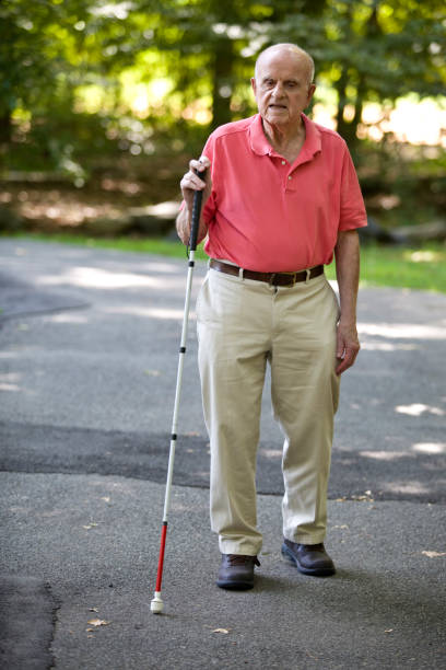 istock Blind person walking with cane in park 1423410859