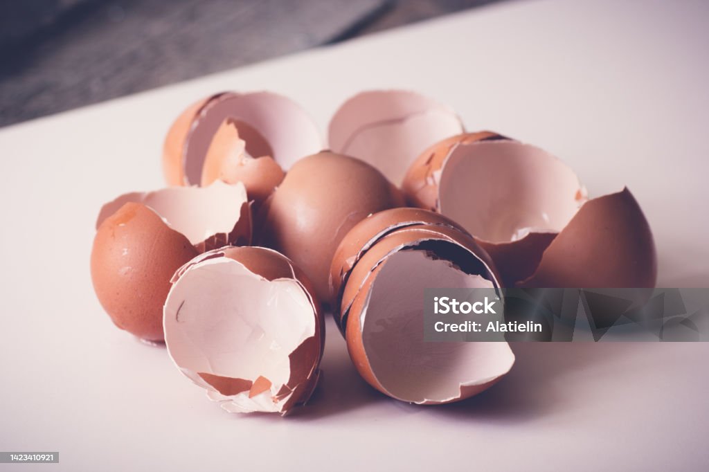 Broken egg shells close up. Eggshell on white table Eggshell Stock Photo