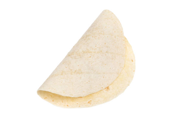 Tortilla on a white background. Thin flatbread close-up on a white background. Tortilla on a white background. Thin flatbread close-up on a white background. pita bread isolated stock pictures, royalty-free photos & images