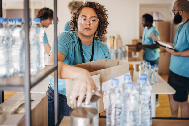 istock Woman sorting donations on a shelf 1423414544