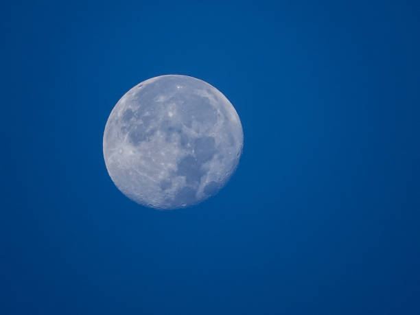 Full moon in a bright blue sky. stock photo