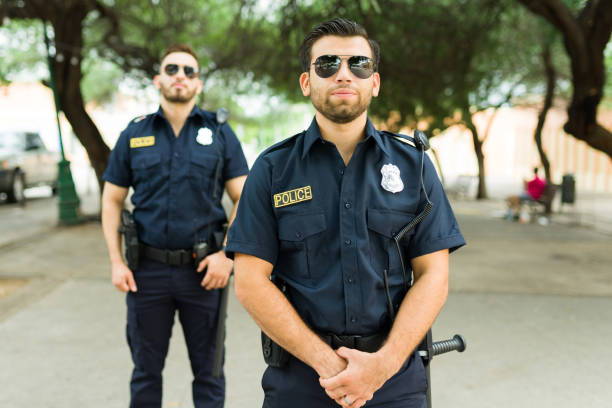 istock Caucasian cops on duty standing outdoors in the park 1423419451