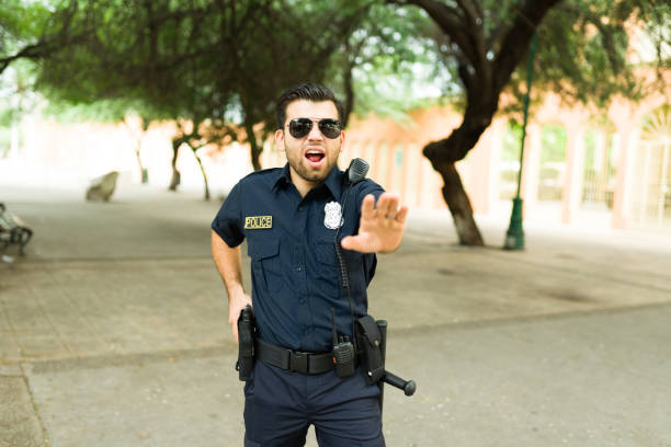 istock Upset policeman screaming to a criminal to arrest him 1423420232