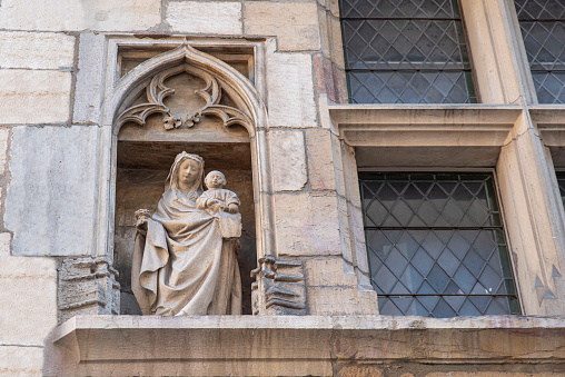Religious statue on the outside of a church in the city centre of Dijon in France