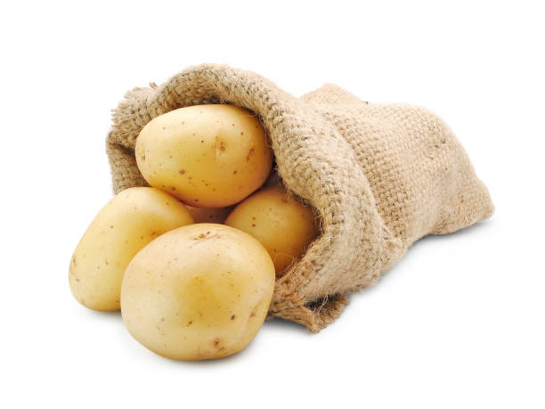 istock Fresh potatoes in burlap sack isolated on white 1423420948