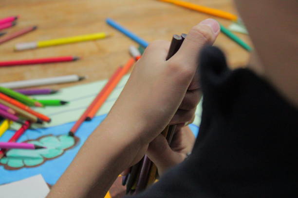 istock Child Painting Drawing with Colored Pencils 1423421078