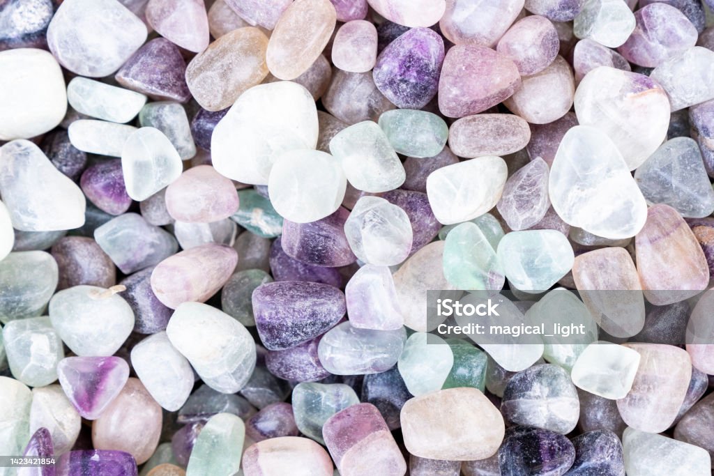 Closeup of various colorful stones quartz, marbles, ore minerals, gems use as ornament and decoration jewelry that contain spiritual force human believes Fluorite Stock Photo