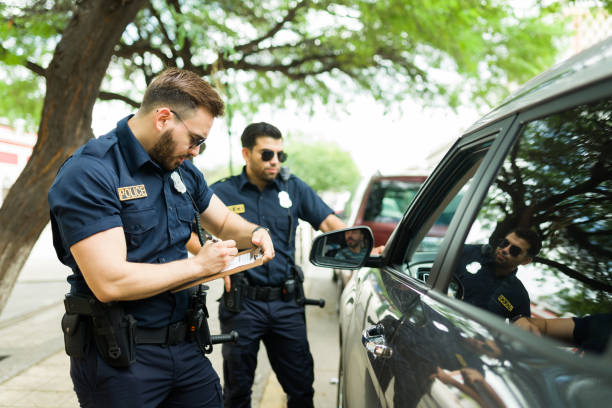 istock Police agents talking with a driver about his speeding ticket 1423424374