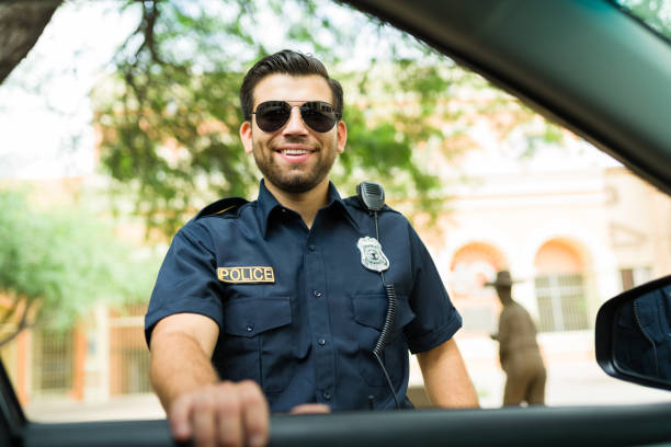 istock Happy police officer looking excited while taking with a driver 1423424650