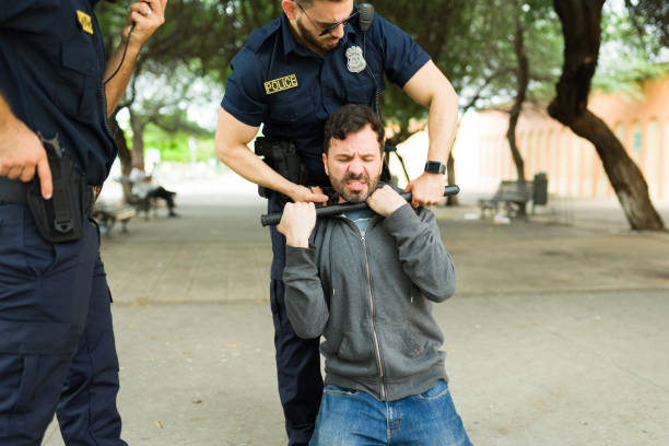 istock Police officers arresting a man after a crime 1423424751