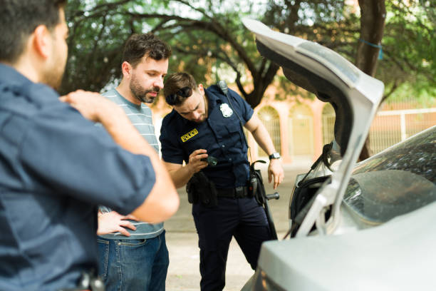 istock Cops searching for criminal evidence in the car trunk 1423424765