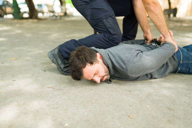 istock Young man criminal getting arrested lying on the floor 1423424896