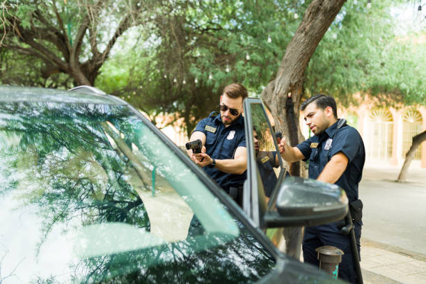 istock Caucasian cops trying to make an arrest of a criminal driver 1423425532