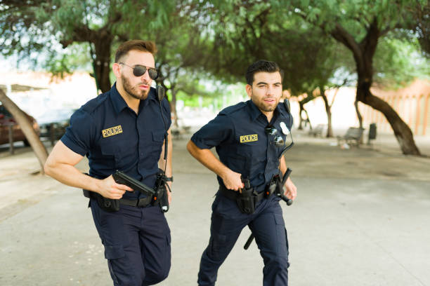 istock Busy police agents ready to arrest a criminal 1423425565
