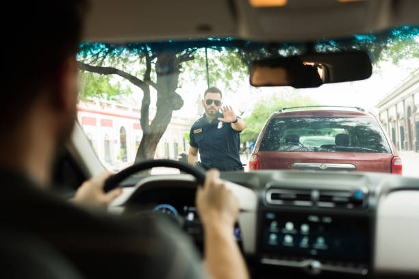 Upset police agent stopping a driver in his car for a parking ticket stock photo
