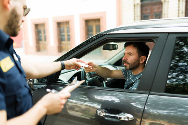 Driver getting a fine parking ticket from a police officer
