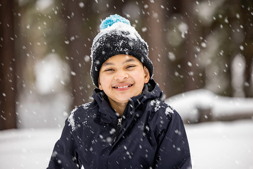 High quality stock photos of a boy playing in the snow at Lake Tahoe during a snow storm.