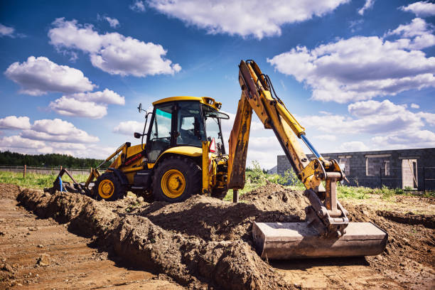 istock Excavator at house construction site - digging foundations for modern house 1423429516