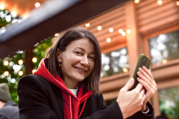 istock Woman using smart phone at coffee shop 1423430116